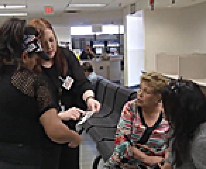 MVD customers and staff in an MVD office