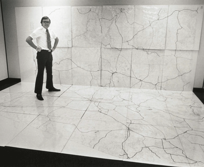Man standing on map on wall and floor