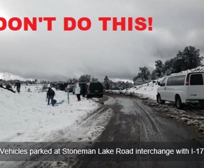 Vehicles stopped to play in snow alongside I17
