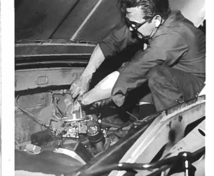 Man working on vehicle engine