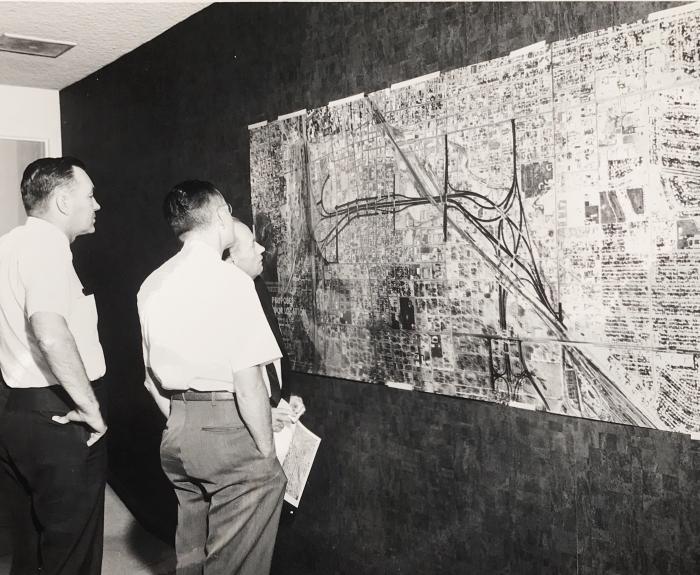 People looking at road map on the wall