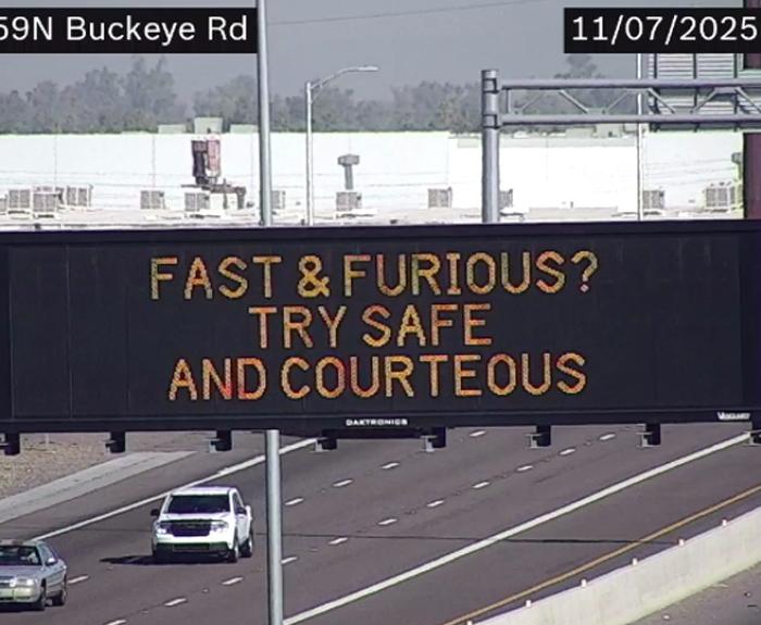 A digital message board on the highway encouraging drivers to drive with care