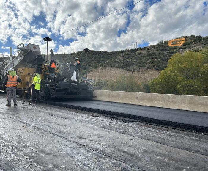 Crews use machinery to create fresh roadway