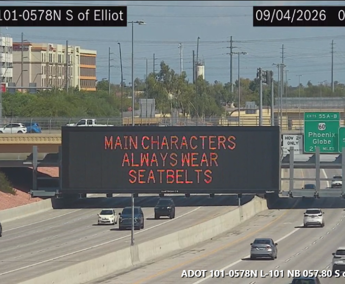A digital highway sign that encourages drivers to wear seat belts.