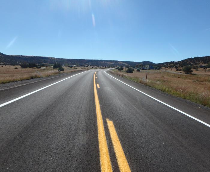Freshly paved road under a blue sky